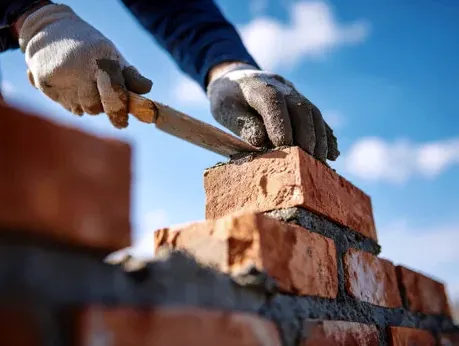 Mason rebuilding chimney brick on a Bear Creek area home in Lakewood